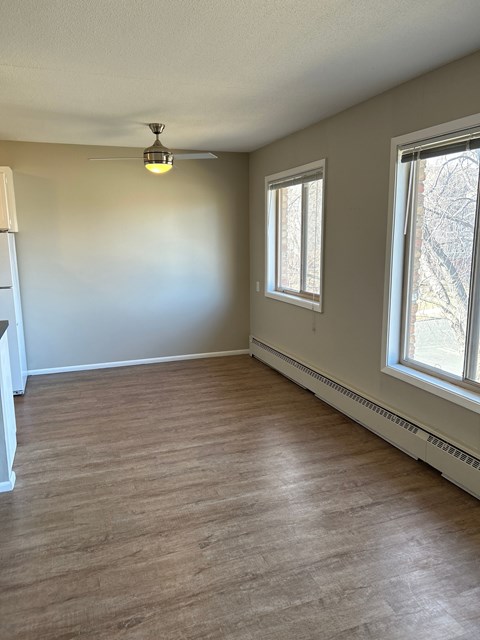 A room with a window and a ceiling fan.